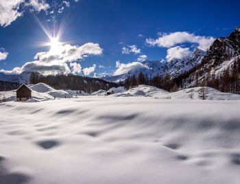 Scenic view of snowcapped mountains against sky during winter