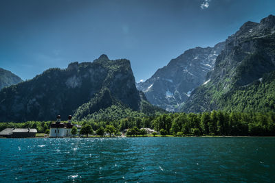 Scenic view of lake by mountains against sky