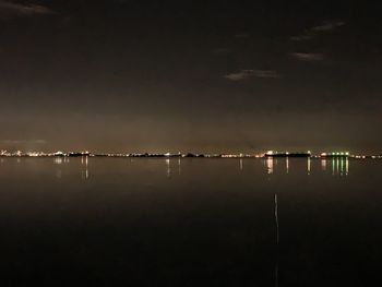 Scenic view of lake against sky at night