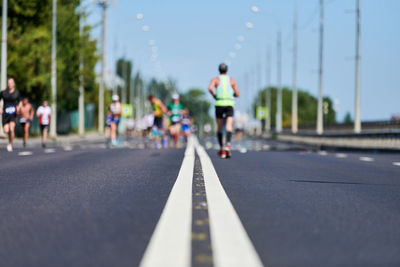 Rear view of man running on road in city