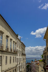 Low angle view of buildings in town against sky