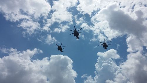 Low angle view of helicopter against sky