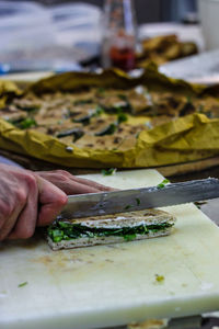 Close-up of person preparing food on table