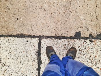 Low section of man standing on footpath