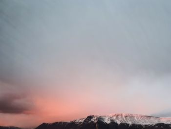 Scenic view of mountains against sky at sunset