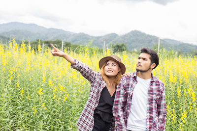 Young couple standing on field