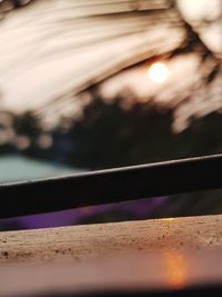 Close-up of illuminated railing by window