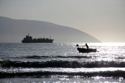 Silhouette of boat sailing in sea