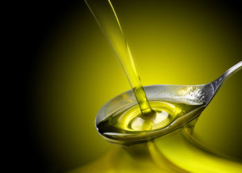Close-up of yellow glass over black background