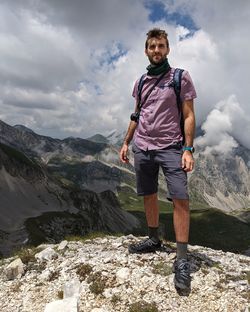 Full length of man standing on mountain against sky