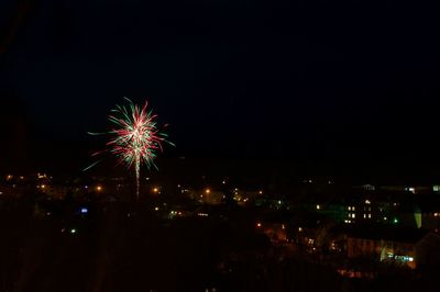 Low angle view of firework display at night