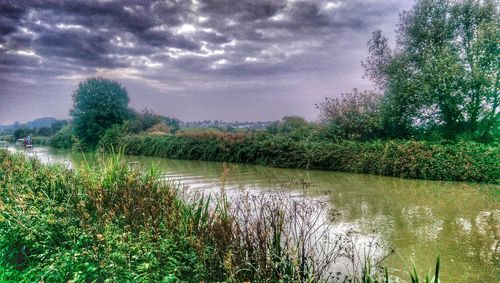 Scenic view of lake against cloudy sky