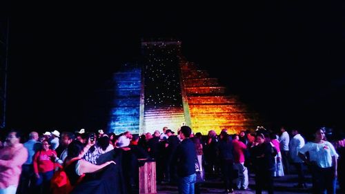 People standing in illuminated building