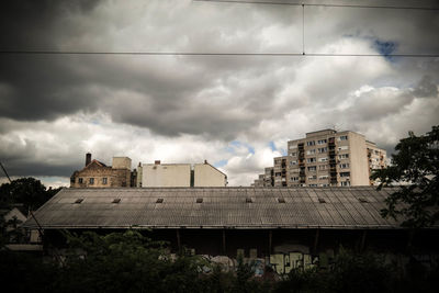 Low angle view of building against cloudy sky