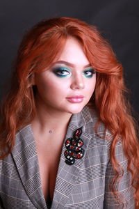 Close-up portrait of sensuous young woman against black background