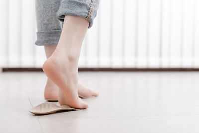 Low section of woman standing on floor