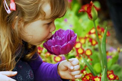 Close-up of girl kissing purple flower