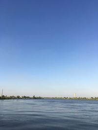 Scenic view of sea against clear blue sky