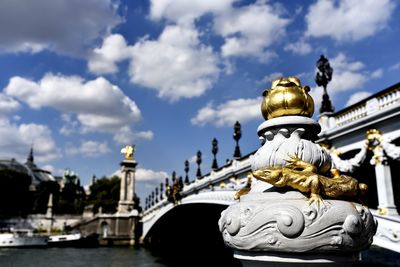 Low angle view of pont alexander iii over river against cloudy sky