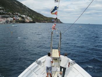 Boat sailing in sea against sky