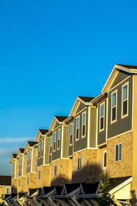 Low angle view of buildings against blue sky