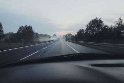 View of road seen through car windshield