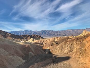 View of desert against cloudy sky