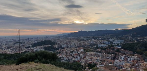 High angle shot of townscape against sky at sunset