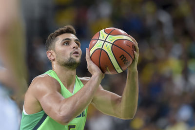 Young man playing with ball in background