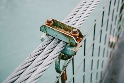 Close-up of rope tied on metal fence