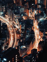 High angle view of illuminated buildings in city at night