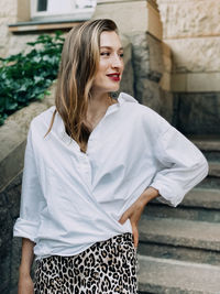 Portrait of young woman standing outdoors