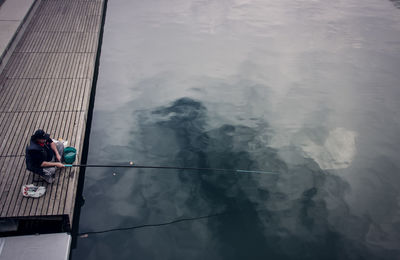 High angle view of man fishing in lake