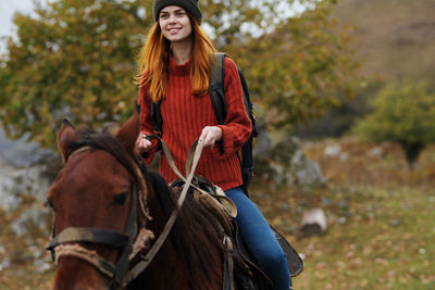 Young woman riding horse