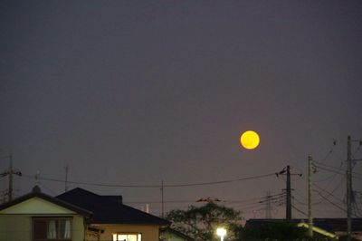 Low angle view of illuminated street light against sky