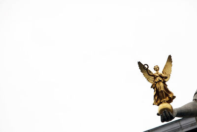 Low angle view of angel statue against clear sky