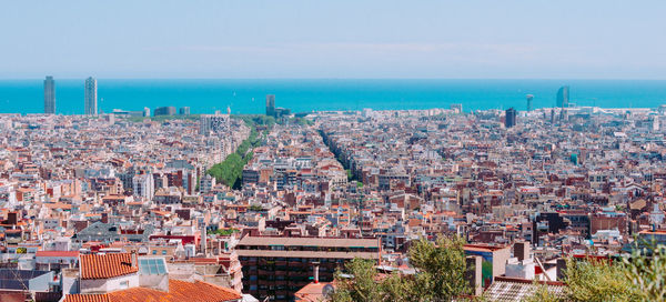 High angle view of townscape by sea against sky