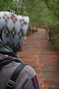 Rear view of man standing on footpath