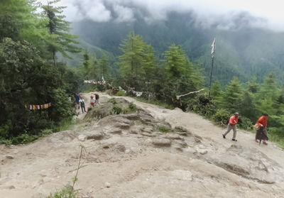 People on mountain against sky