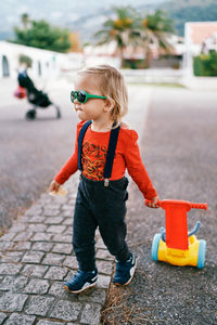 Full length of boy standing on road