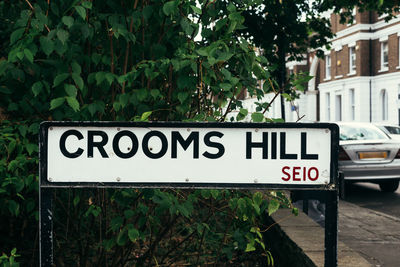 Information sign against trees in city