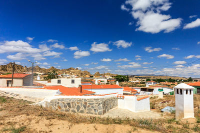Houses in town against blue sky