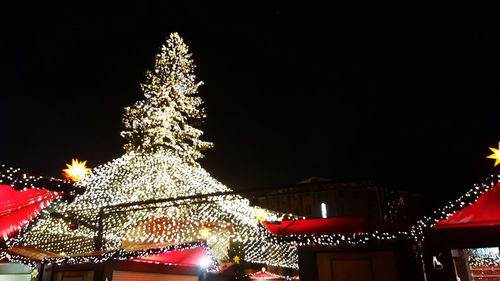 Low angle view of illuminated lights at night