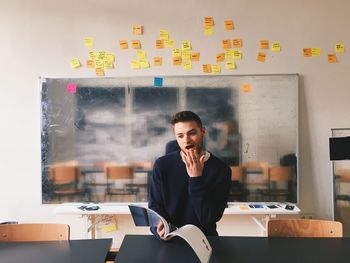 Portrait of man working on table