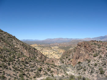 Scenic view of mountains against blue sky