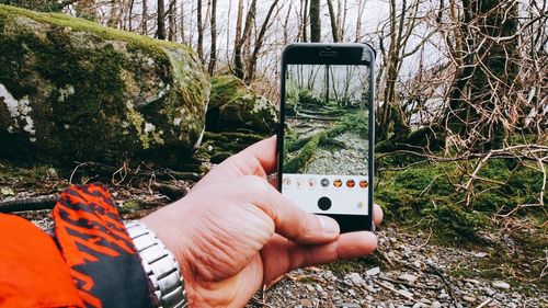 Close-up of man taking picture from phone