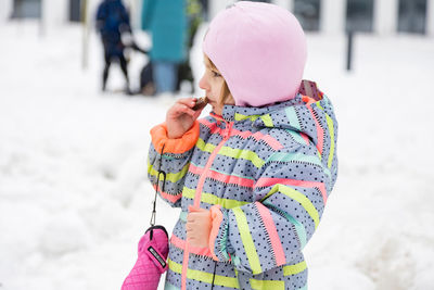 Little girl eating pankakes on maslenitsa festival russian winter tradinion holiday