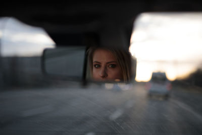 Portrait of young woman in car