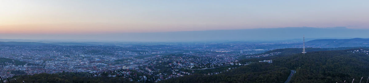 Aerial view of cityscape against sky during sunset