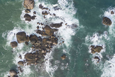 High angle view of rocks in sea